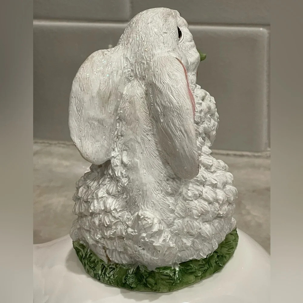 Cute rabbit with carrots statute - rabbit sparkles in light (see video)